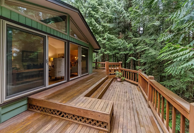 A wooden deck with a bench on it