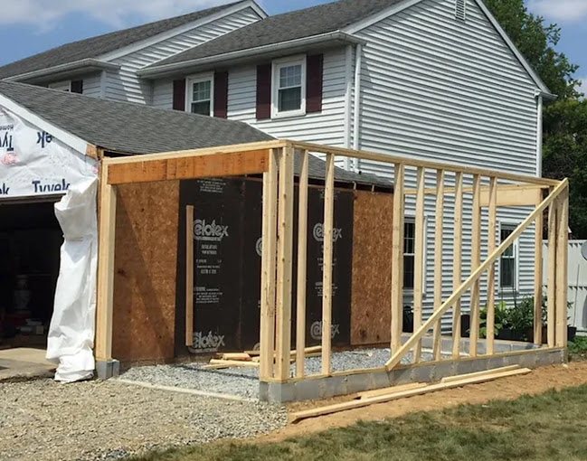 A house being built in the middle of a yard