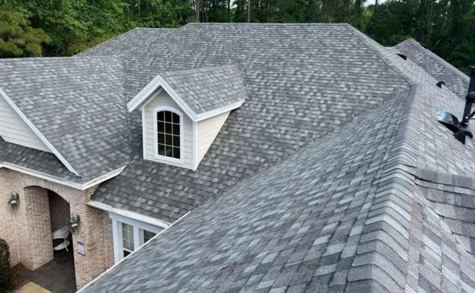 A house with a gray roof and white trim