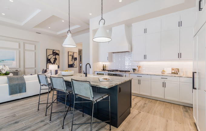 A large kitchen with a center island and bar stools