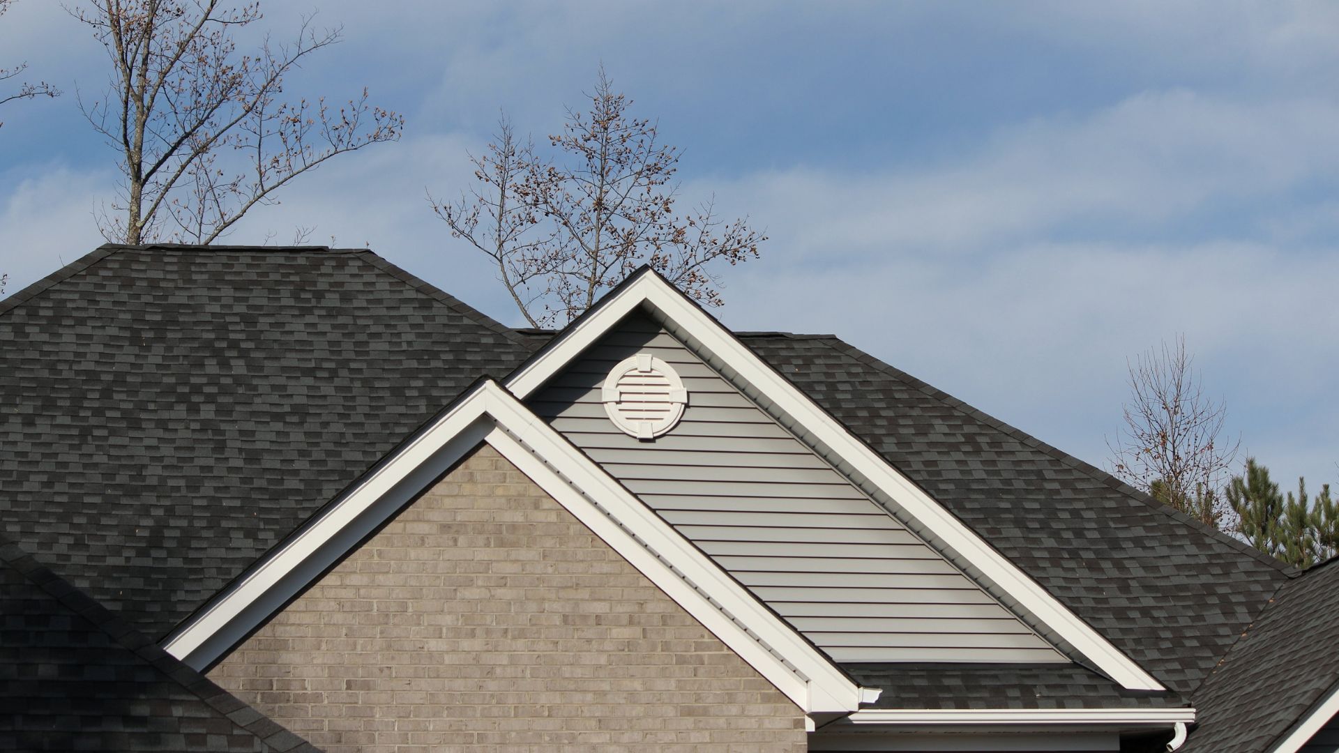 The roof of a house with a clock on it